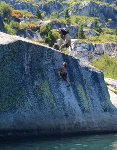 Isaac Caldiero backflips while Dave Hatchett climbs "Crystal Clear" v2/3 at Anogora Lakes.